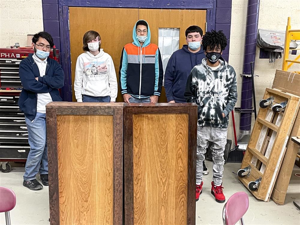 Tech Ed students posing with the 2 podiums they built